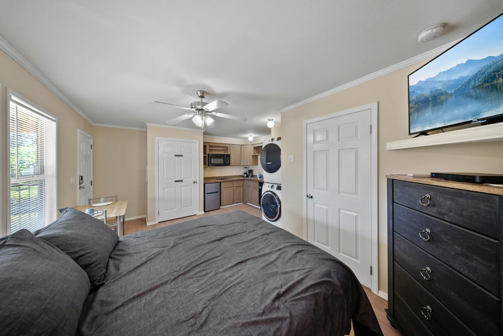 Cypress suite with queen bed, dresser, TV and kitchenette