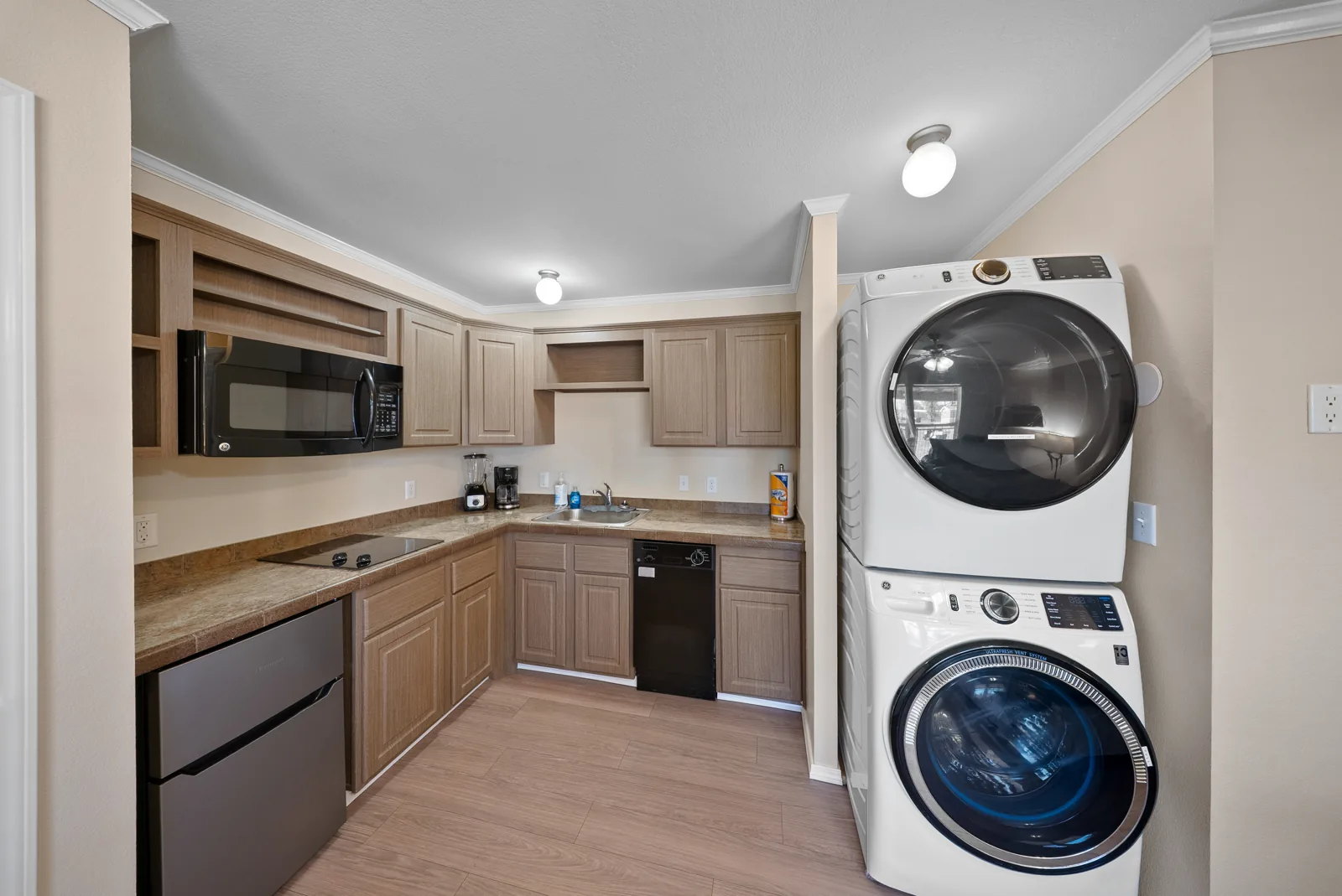 Cypress kitchenette with stacked laundry