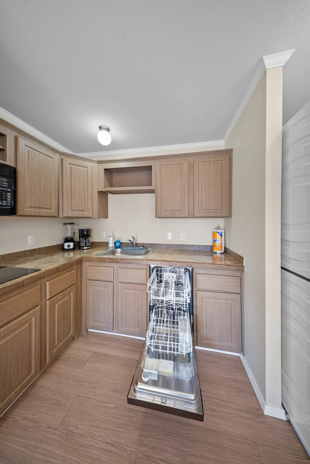 Cypress kitchenette with the dishwasher open